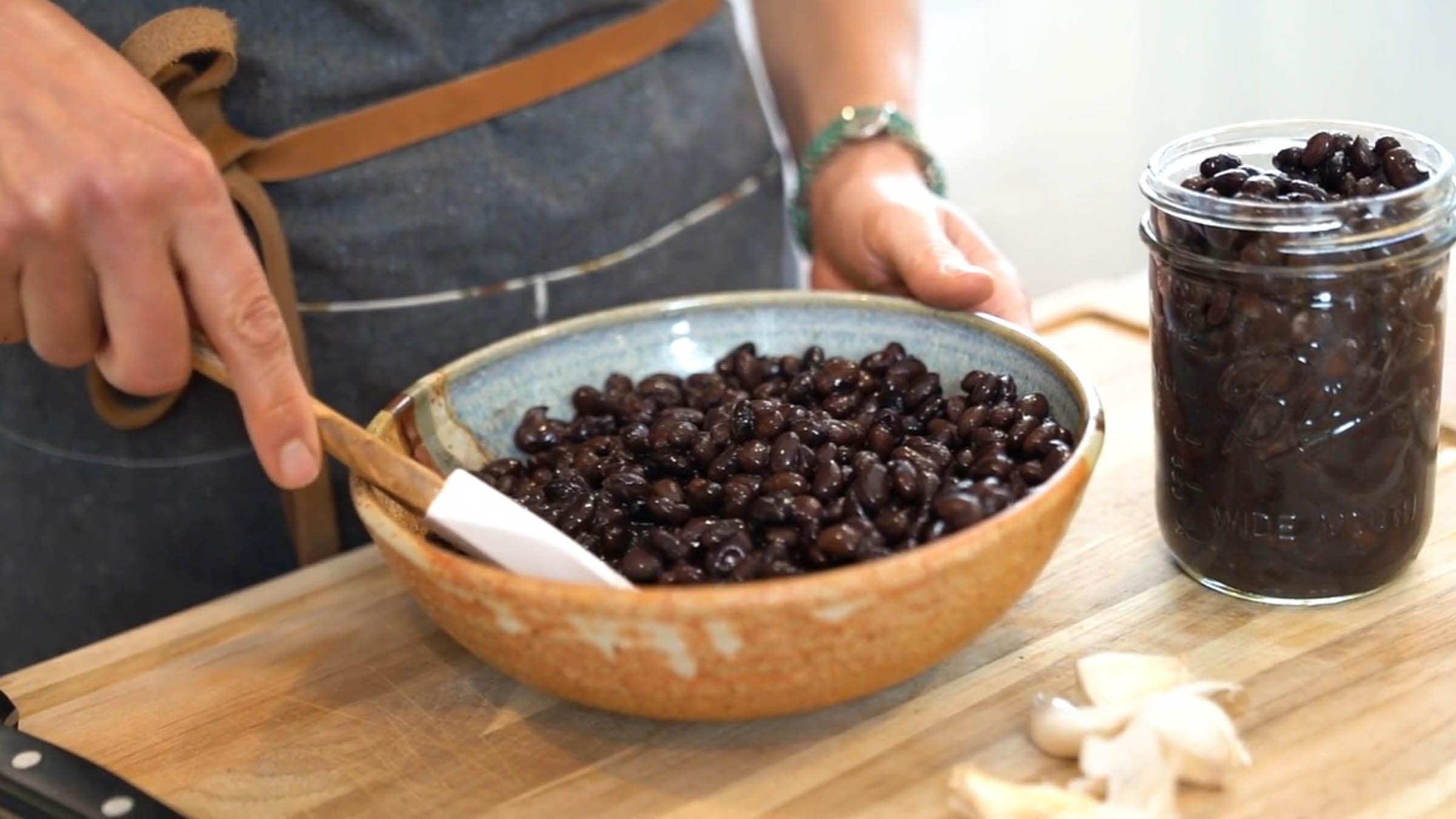 Black beans being stirred in a bowl