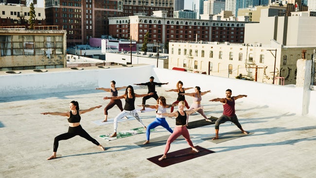 photo of a rooftop yoga class to illustrate a story about vegan yoga